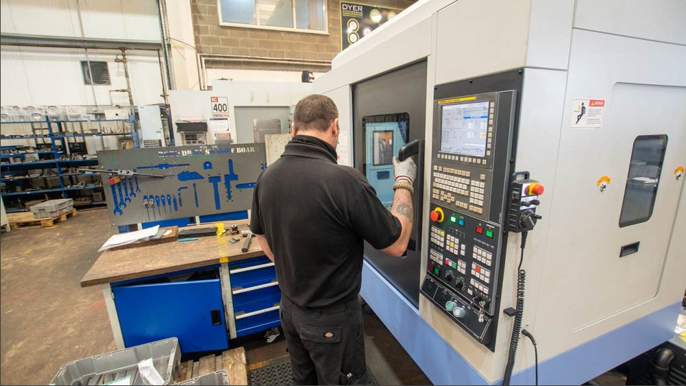 Dyer Engineering staff working on CNC machine